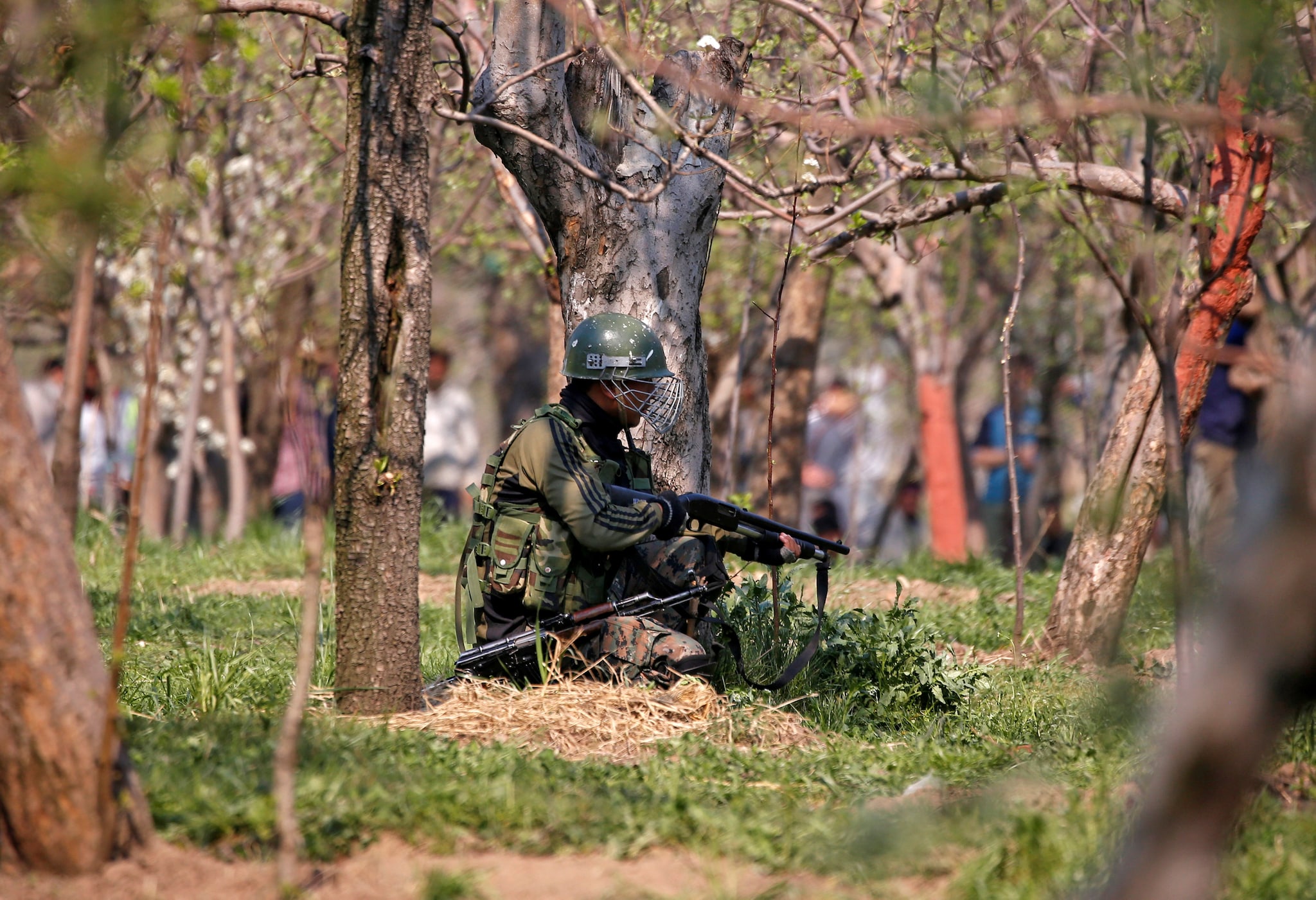 An Indian army soldier takes his position in an orchard near the site of a gunbattle with suspected militants at Kachdoora village in south Kashmir's Shopian district April 1, 2018. REUTERS/Danish Ismail