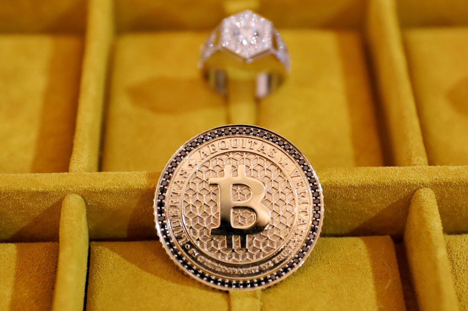 Jewelry with the Bitcoin logo is seen on display at the Consensus 2018 blockchain technology conference in New York City,