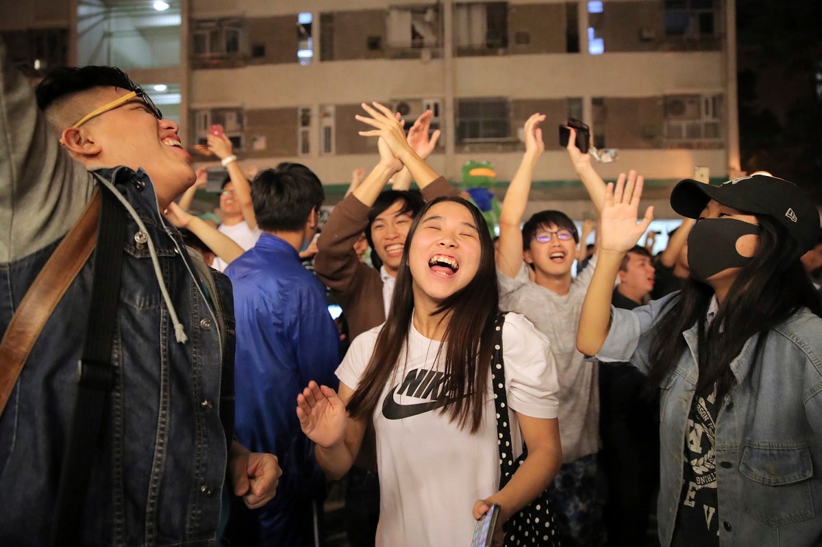 In this Monday, Nov. 25, 2019, file photo, pro-democracy supporters celebrate after pro-Beijing politician Junius Ho lost his election in Hong Kong. Vote counting was underway in Hong Kong early Monday after a massive turnout in district council elections seen as a barometer of public support for pro-democracy protests that have rocked the semi-autonomous Chinese territory for more than five months. (AP Photo/Kin Cheung, File)