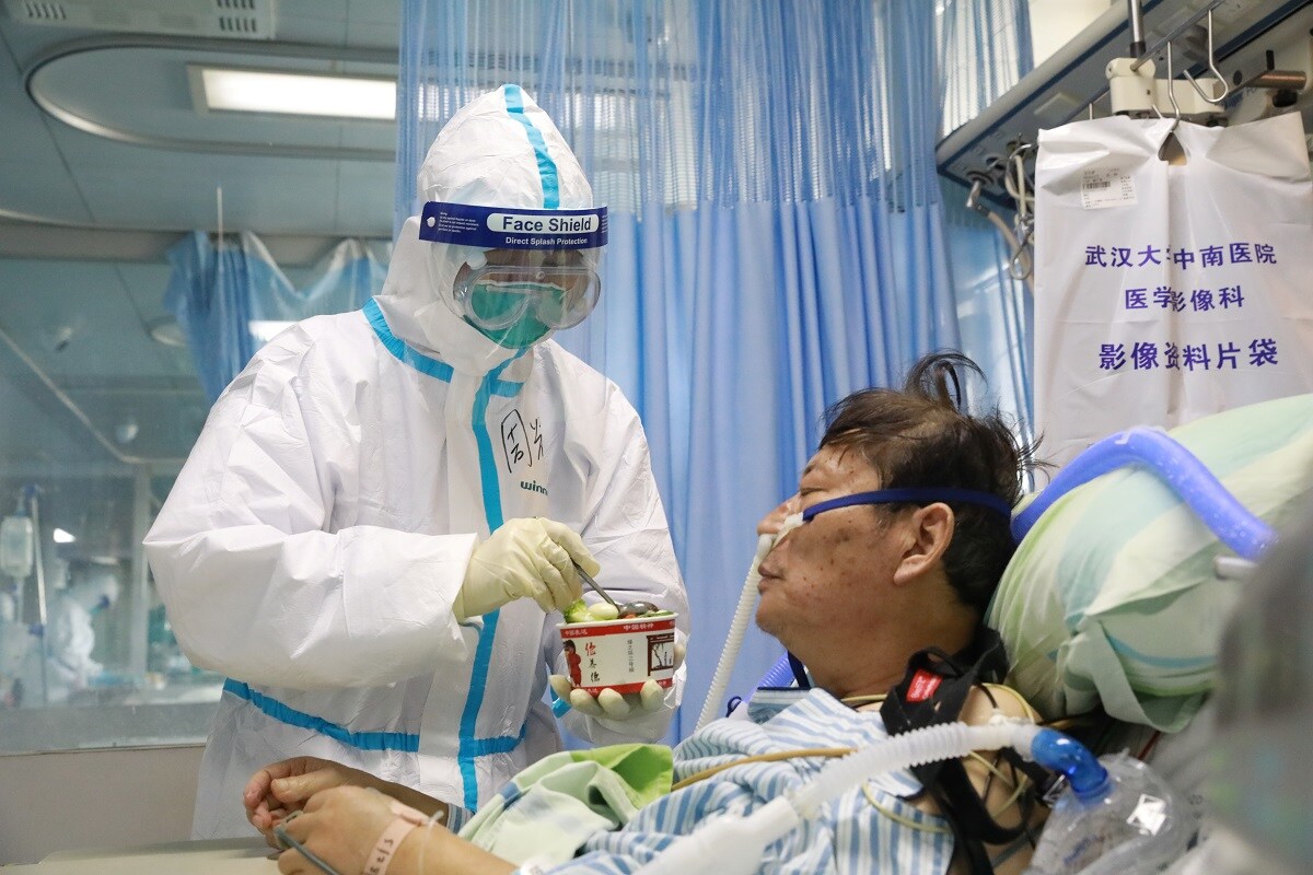 A nurse in a protective suit feeds a novel coronavirus patient inside an isolated ward at Zhongnan Hospital of Wuhan University, during the Lantern Festival, which marks the end of the Chinese Lunar New Year celebrations, in Wuhan, Hubei province, China February 8, 2020. China Daily via REUTERS