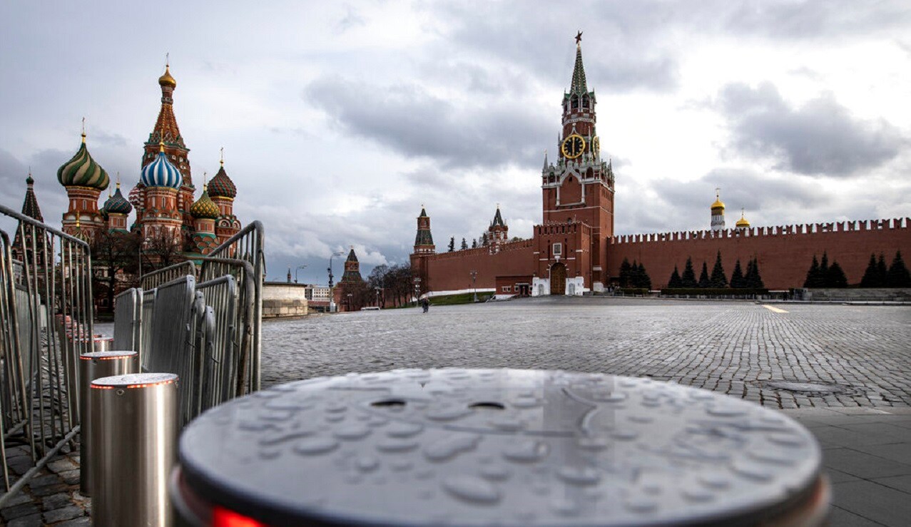 An almost empty Red Square, with St. Basil's Cathedral the Spasskaya Tower, right, and a security fence after a light rain at 18:00 on Friday, April 24, 2020 in Moscow, Russia. (AP Photo/Alexander Zemlianichenko)