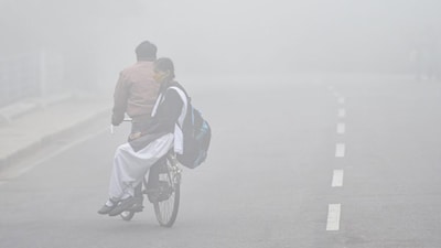 Lucknow: A student on her way to school, amid dense fog, during a cold morning, in Lucknow, Friday, Dec. 11, 2020. (PTI Photo/Nand Kumar)(PTI11-12-2020_000022B)