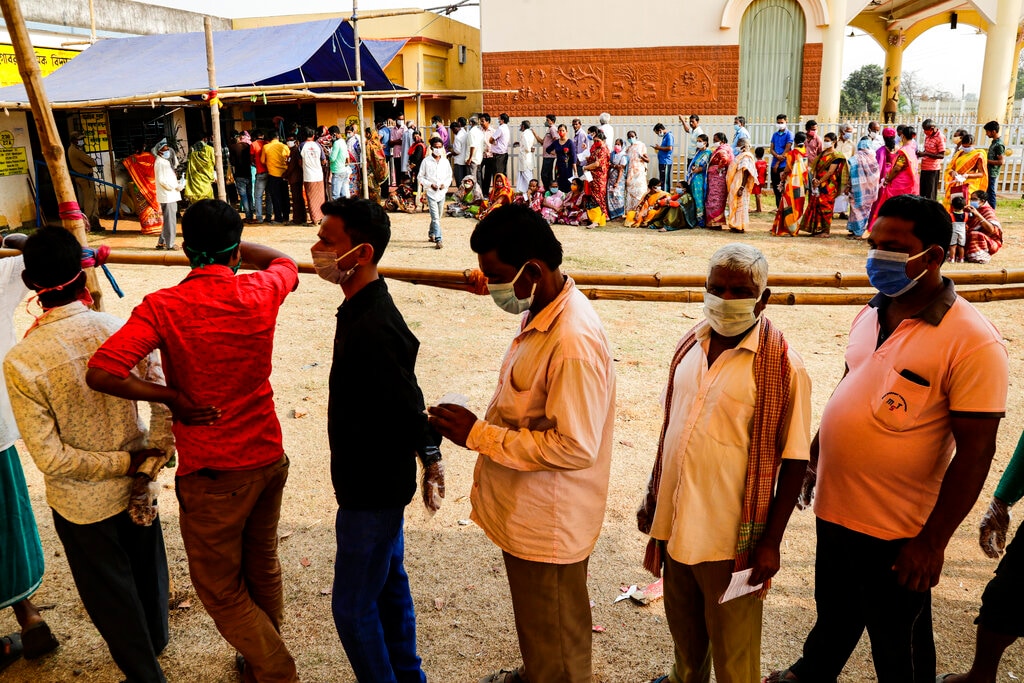 FILE: Voters stand in queues to cast their votes outside a polling booth during first phase of elections in West Bengal (AP Photo/Bikas Das)