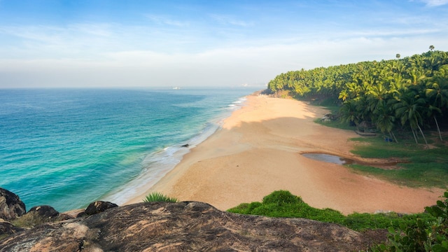 8. Kovalam Beach, Tamil Nadu | Kovalam Beach, located in Tamil Nadu, is a popular tourist spot known for its crescent-shaped coastline and scenic beauty. It attracts visitors with its vibrant atmosphere, excellent infrastructure, and variety of water sports. The Blue Flag certification underscores its dedication to preserving the beach’s ecological balance and safety standards.