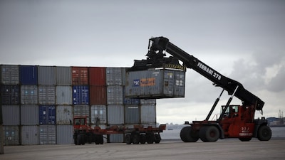 A worker unloads a container using a forklift at a port in Lisbon March 12, 2013. Portugal's global trade deficit shrunk by 31 percent in the three months between November and January from the same period a year earlier, as exports of goods edged up 1 percent while imports fell over 6 percent due to a drop in internal demand, the National Statistics Institute said on Tuesday.   REUTERS/Rafael Marchante (PORTUGAL - Tags: BUSINESS)