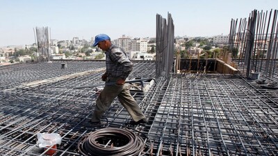 A Palestinian labourer works on the roof of a hotel under construction in the West Bank city of Ramallah July 29, 2010. The din of earth-movers levelling the hilly terrain of Ramallah for construction is unremitting as modern buildings shoot up all over the West Bank city. Picture taken July 29, 2010. To match Feature PALESTINIANS-ISRAEL/CONSTRUCTION. REUTERS/Mohamad Torokman (WEST BANK - Tags: BUSINESS CONSTRUCTION)