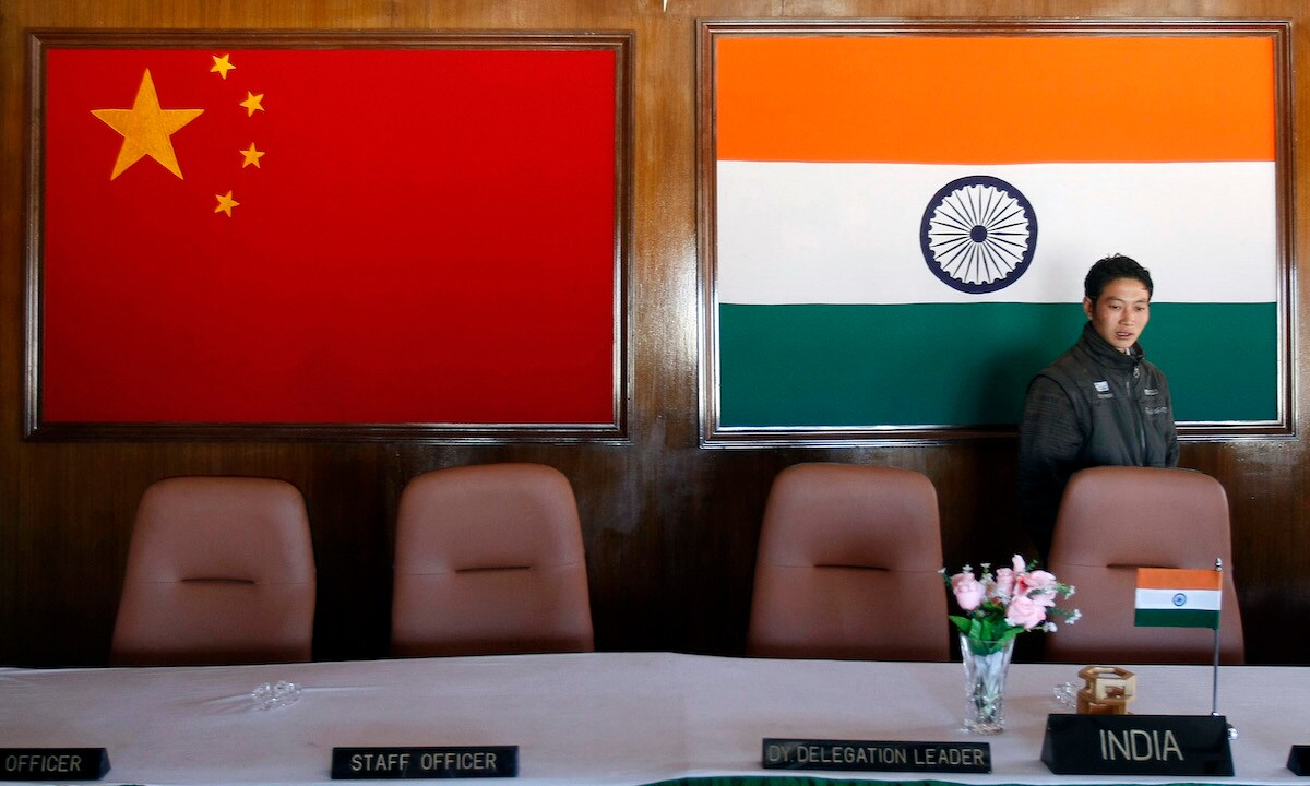 FILE PHOTO: A man walks inside a conference room at the Indian side of the Indo-China border at Bumla, in the northeastern Indian state of Arunachal Pradesh, November 11, 2009. REUTERS/Adnan Abidi/File Photo