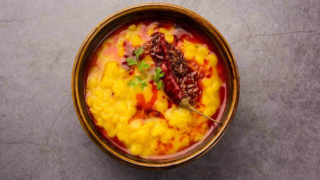 Rank No 30. Dal tadka | A comforting staple of Indian cuisine, Dal Tadka delights with its harmonious blend of lentils, tempered with aromatic spices and finished with a drizzle of clarified butter.