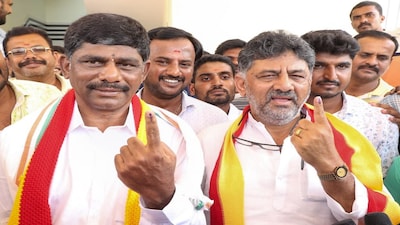 Kanakpura: Karnataka Dy CM D K Shivakumar and his brother D K Suresh show their fingers marked with indelible ink after casting their votes for the 2nd phase of Lok Sabha elections, in Kanakpura, Friday, April 26, 2024. (PTI Photo) (PTI04_26_2024_000269B)