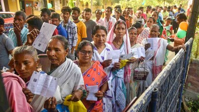 People wait to cast their votes for the second phase of Lok Sabha elections, at Mayong in Morigaon district, Assam. (PTI)
