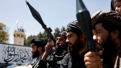 Taliban soldiers celebrate on the second anniversary of the fall of Kabul on a street near the US embassy in Kabul, Afghanistan, August 15, 2023. REUTERS/Ali Khara 