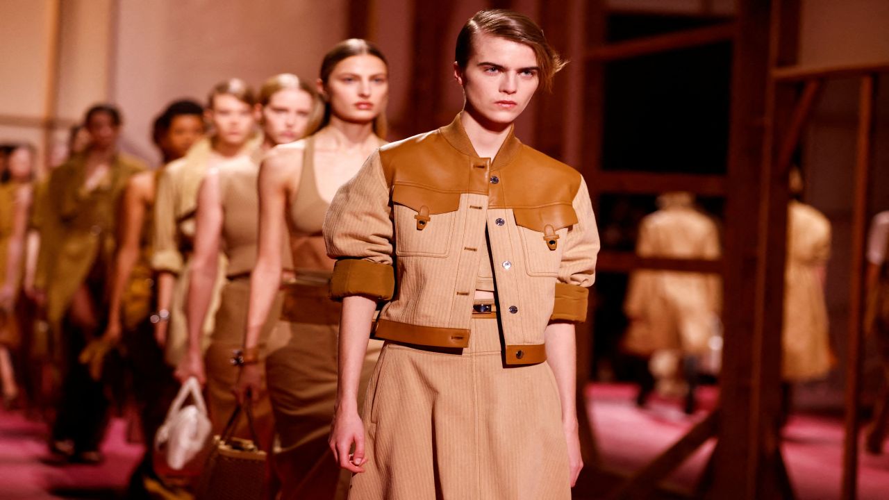 Paris Fashion Week: Trio of protesters disrupt Hermes catwalk as models showcase tan leather designs