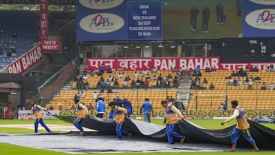 Bengaluru: Ground staff cover the pitch during rains on the first day of the first test cricket match between India and New Zealand, at M Chinnaswamy Stadium in Bengaluru, Wednesday, Oct 16, 2024. The first day of the test match was called off due to rain. (PTI Photo/Shailendra Bhojak) (PTI10_16_2024_000166B)