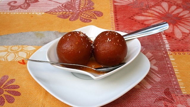 No 7. Dish: Gulab Jamun | Origin: Persia/Central Asia | The Persian sweet "luqmat al-qadi" is the origin of our favourite festival dessert. Deep-fried khoya balls dipped in rose syrup were modified by Mughal chefs to evolve into the holiday mainstay we currently enjoy. No 7. Dish: Gulab Jamun | Origin: Persia/Central Asia | The Persian sweet "luqmat al-qadi" is the origin of our favourite festival dessert. Deep-fried khoya balls dipped in rose syrup were modified by Mughal chefs to evolve into the holiday mainstay we currently enjoy.
