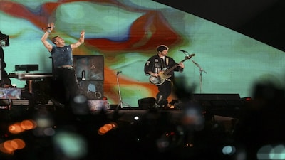 Navi Mumbai: British band Coldplays Chris Martin, left, and Guy Berryman perform during the bands Music Of The Spheres World Tour Produced and Promoted By BookMyShow Live, at the D Y Patil Sports Stadium, in Navi Mumbai, Saturday, Jan. 18, 2025. (PTI Photo/Kunal Patil) (PTI01_18_2025_000282B)