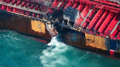 Water flows through a damaged hull of Stena Immaculate oil tanker ship after it collided with a cargo ship off the northeastern coast of England, Britain, March 11, 2025. REUTERS/Phil Noble

