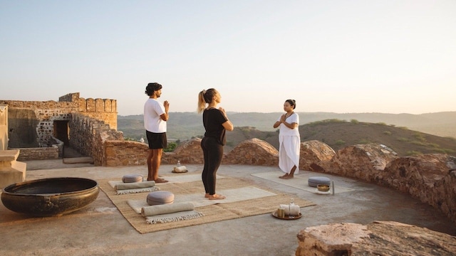 Immerse yourself in the ancient discipline of hatha yoga at Six Senses Fort Barwara, where wellness meets history in a tranquil sanctuary. Set against a stunning 14th-century fort, the “Discover Yoga” program encourages guests to reconnect with their bodies, soothe the mind, and restore balance through mindful movement and breathwork. Whether you are new to yoga or a seasoned practitioner seeking deeper alignment, the program is crafted to enhance strength, flexibility, relieve tension, and foster a lasting sense of inner harmony. Immerse yourself in the ancient discipline of hatha yoga at Six Senses Fort Barwara, where wellness meets history in a tranquil sanctuary. Set against a stunning 14th-century fort, the “Discover Yoga” program encourages guests to reconnect with their bodies, soothe the mind, and restore balance through mindful movement and breathwork. Whether you are new to yoga or a seasoned practitioner seeking deeper alignment, the program is crafted to enhance strength, flexibility, relieve tension, and foster a lasting sense of inner harmony.