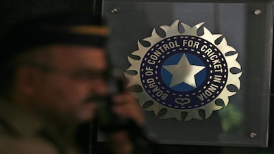 A policeman walks past a logo of the Board of Control for Cricket in India (BCCI) during a governing council meeting of the Indian Premier League (IPL) at BCCI headquarters in Mumbai April 26, 2010. Indian Premier League chief Lalit Modi has been suspended, officials said on Monday, after graft accusations in cricket's richest event ensnared top politicians and Bollywood stars and strained the ruling coalition. REUTERS/Arko Datta (INDIA - Tags: SPORT CRICKET)