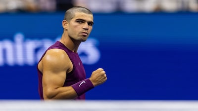 Aug 25, 2025; Flushing, NY, USA; Carlos Alcaraz of Spain in action against Reilly Opelka of the United States in the first round of the men’s singles at the US Open at Arthur Ashe Stadium in Billie Jean King National Tennis Centre. Mandatory Credit: Mike Frey-Imagn Images