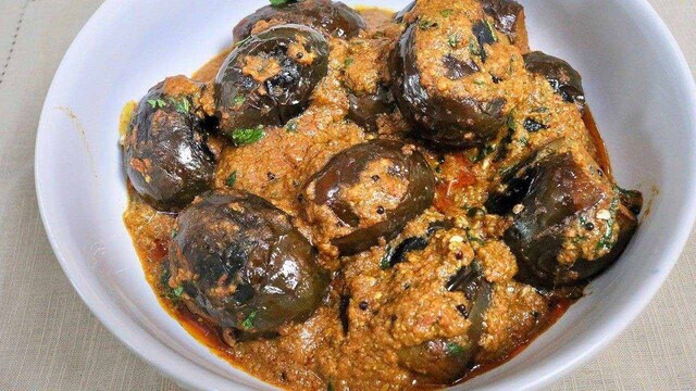 6. Bagara Baingan | Bagara Baingan is a rich Hyderabadi curry made with baby brinjals (eggplants) cooked in a thick gravy of peanuts, sesame seeds, coconut, and tamarind. The dish is known for its bold, nutty, and tangy flavour profile. It pairs perfectly with biryani or plain rice and is a staple at traditional feasts.