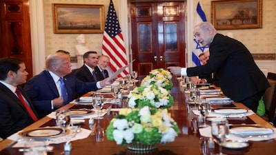 U.S. President Donald Trump receives a nomination letter after Israeli Prime Minister Benjamin Netanyahu told him he nominated him for the Nobel Peace Prize, during a bilateral dinner, with U.S. Defense Secretary Pete Hegseth and U.S. Secretary of State Marco Rubio in attendance, at the White House in Washington, D.C., U.S., July 7, 2025. REUTERS/Kevin Lamarque