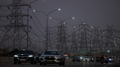 Vehicles move past electricity pylons in Gurugram, India, September 11, 2025. REUTERS/Bhawika Chhabra