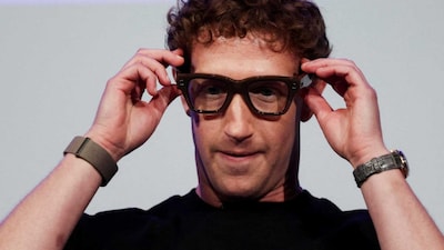 Meta CEO Mark Zuckerberg wears the Meta Ray-Ban Display glasses, as he delivers a speech presenting the new line of smart glasses, during the Meta Connect event at the company's headquarters in Menlo Park, California, U.S., September 17, 2025. REUTERS/Carlos Barria 