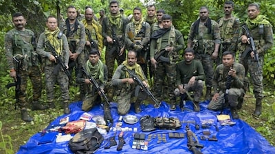 Security personnel pose with the arms, ammunition and other items recovered from maoists during a gunfight, in Palamu district, Jharkhand, Sunday, Sept. 14, 2025. A Maoist was killed in the gunfight. (PTI Photo)