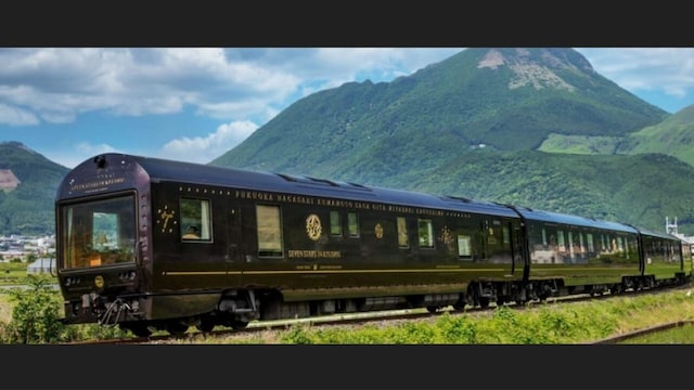 Seven Stars Kyushu, JapanIt is a luxury train in Japan that offers an exclusive, scenic journey around Kyushu Island. The train travels through mountains, coastlines, hot springs, and lush countryside. Passengers can enjoy views of forests, rivers, volcanoes, and the famous Mount Aso. With wooden interiors and traditional Japanese decor, the train offers luxurious suites and lounges, complemented by gourmet meals. Seven Stars Kyushu, JapanIt is a luxury train in Japan that offers an exclusive, scenic journey around Kyushu Island. The train travels through mountains, coastlines, hot springs, and lush countryside. Passengers can enjoy views of forests, rivers, volcanoes, and the famous Mount Aso. With wooden interiors and traditional Japanese decor, the train offers luxurious suites and lounges, complemented by gourmet meals.