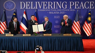 Malaysia's Prime Minister Anwar Ibrahim, left, and U.S. President Donald Trump, right, watch as Thailand's Prime Minister Anutin Charnvirakul, second left, and Cambodia's Prime Minister Hun Manet hold up a document after the ceremonial signing of a ceasefire agreement between Thailand and Cambodia on the sidelines of the 47th Association of Southeast Asian Nations (ASEAN) summit in Kuala Lumpur, Malaysia, Sunday, Oct. 26, 2025. (Mohd Rasfan/Pool Photo via AP)