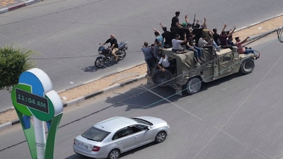Palestinian militants drive a captured Israeli military vehicle in Gaza City on Saturday, Oct. 7, 2023. (AP Photo/Hatem Moussa)