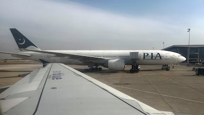 Pakistan International Airlines (PIA) passenger plane sits on tarmac, as seen through a plane window, at the Islamabad International Airport, Islamabad, Pakistan October 27, 2024. REUTERS/Akhtar Soomro