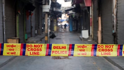 A man walks through a closed market as the area is cordoned off with police tape at the site of an explosion near the historic Red Fort in the old quarters of Delhi, India, November 11, 2025. REUTERS/Adnan Abidi