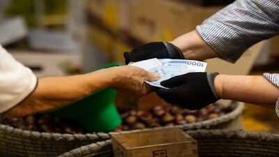A customer pays his purchase with South Korean 1,000 won banknotes at the Cheongyangni Market in Seoul, South Korea, on Friday, Sept. 13, 2024. South Koreas inflation slowed more than expected to the central banks target, opening the door for monetary officials to conduct a policy pivot as soon as next month if home prices also show signs of easing.