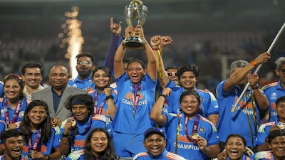 Navi Mumbai: Indias captain Harmanpreet Kaur, center, lifts the trophy as team members and others celebrate after winning ICC Women's World Cup 2025, at the DY Patil Stadium, in Navi Mumbai, early Monday, Nov. 3, 2025. (PTI Photo/Kunal Patil) (PTI11_03_2025_000075B)