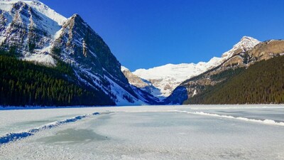 Lake Louise: Canada’s alpine fairy-tale under ice. Surrounded by snow-capped peaks and pine forests, the lake transforms into a pristine white rink each winter, perfect for ice skating, photography and serene walks on frozen water. (Image: Canva)