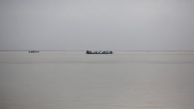 People commute by boat near the international border between India and Bangladesh, in the Brahmaputra river in Dhubri district, in the northeastern state of Assam, India August 4, 2018. Picture taken August 4, 2018. REUTERS/Adnan Abidi
