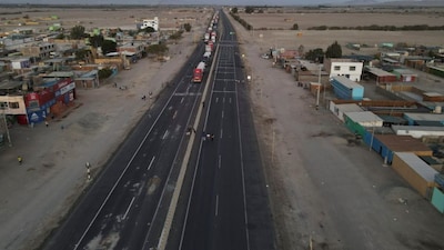 Trucks are parked on the Pan-American highway, one of the key highways essential for food supplies in Peru's largest cities, during protests sparked by rising fuel and fertilizer costs, due to sanctions on Russia, in Villacuri, Peru April 6, 2022. Picture taken April 6, 2022. Picture taken with a drone. REUTERS/Alessandro Cinque