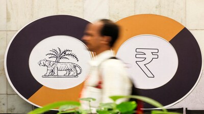FILE PHOTO: A man walks past a logo of the Reserve Bank of India (RBI) and the Indian Rupee inside the RBI headquarters in Mumbai, India, December 6, 2024. REUTERS/Francis Mascarenhas/File Photo