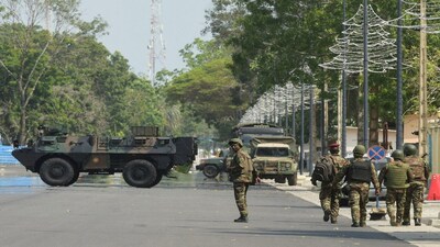 Soldiers patrol in front of the headquarters of Benin's radio and television station, after, according to Benin's Interior Minister, the country's armed forces thwarted the attempted coup against the government of Benin's President Patrice Talon, in Cotonou, Benin, December 7, 2025. REUTERS/Charles Placide Tossou
