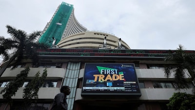 FILE PHOTO: A man walks near a screen outside the Bombay Stock Exchange (BSE) in Mumbai, India, August 28, 2025. REUTERS/Francis Mascarenhas/File Photo