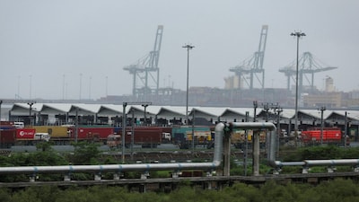 FILE PHOTO: Trucks with shipping containers are parked at Jawaharlal Nehru Port, in Navi Mumbai, India, August 27, 2025. REUTERS/Francis Mascarenhas/File Photo