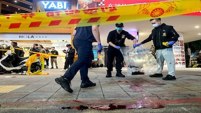 SENSITIVE MATERIAL. THIS IMAGE MAY OFFEND OR DISTURB Police collect evidence from a crime scene outside Eslite Spectrum Nanxi store near Zhongshan station as the entrance of the building is cordoned off with yellow crime scene tape, following an incident in which several were injured after a person released smoke bombs and attacked bystanders, according to the government and local media, in Taipei, Taiwan, December 19, 2025. REUTERS/Ann Wang     TPX IMAGES OF THE DAY