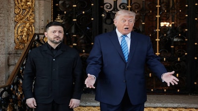 Ukrainian President Volodymyr Zelenskiy stands next to U.S. President Donald Trump as Trump gestures while replying to questions from the media upon Zelenskiy's arrival for meetings at Trump's Mar-a-Lago club in Palm Beach, Florida, U.S., December 28, 2025. REUTERS/Jonathan Ernst