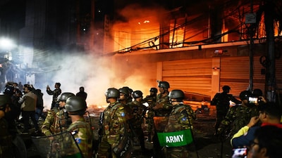 Bangladesh army stands guard at the premises of the Prothom Alo daily newspaper after angry protesters set it on fire after news reached the country from Singapore of the death of a prominent activist Sharif Osman Hadi, in Dhaka, Bangladesh, Friday, Dec. 19, 2025. ap/pti(AP12_19_2025_000003B)