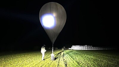 FILE - In this undated photo released by the State Border Guard Service, an officer inspects a balloon used to carry cigarettes into Lithuania, because Belarussian smugglers often use them to ferry the contraband into the European Union (State Border Guard Service via AP, File)