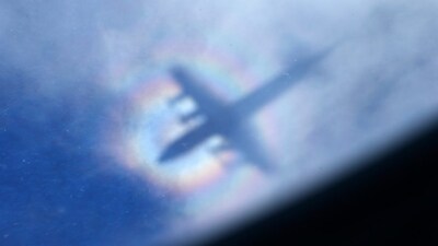 FILE -The shadow of a Royal New Zealand Air Force P3 Orion is seen on low level cloud while the aircraft searches for missing Malaysia Airlines Flight MH370 in the southern Indian Ocean, near the coast of Western Australia, March 31, 2014. (AP Photo/Rob Griffith, File)