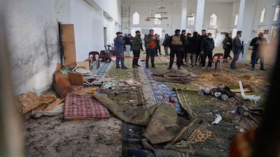Syrian security forces inspect the damage after an explosion in the Imam Ali bin Abi Talib Mosque in a predominantly Alawite area of the Wadi al-Dhahab neighborhood in Homs, Syria Friday, Dec. 26, 2025.(AP Photo)