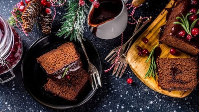Three-Ingredient Christmas Cake | An incredibly simple recipe perfect for last-minute preparation or dietary needs. To prepare this, you will just need dried fruit mix, chocolate milk and flour. Begin by soaking the dried fruit in chocolate milk overnight. The next day, stir in the flour and bake the batter. (Image: Canva)