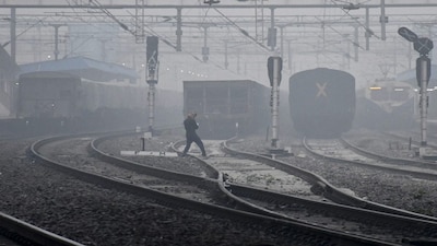 Prayagraj: A man crosses a railway track amid dense fog on a winter morning, in Prayagraj, Thursday, Nov. 20, 2025. (PTI Photo)(PTI11_20_2025_000037B)